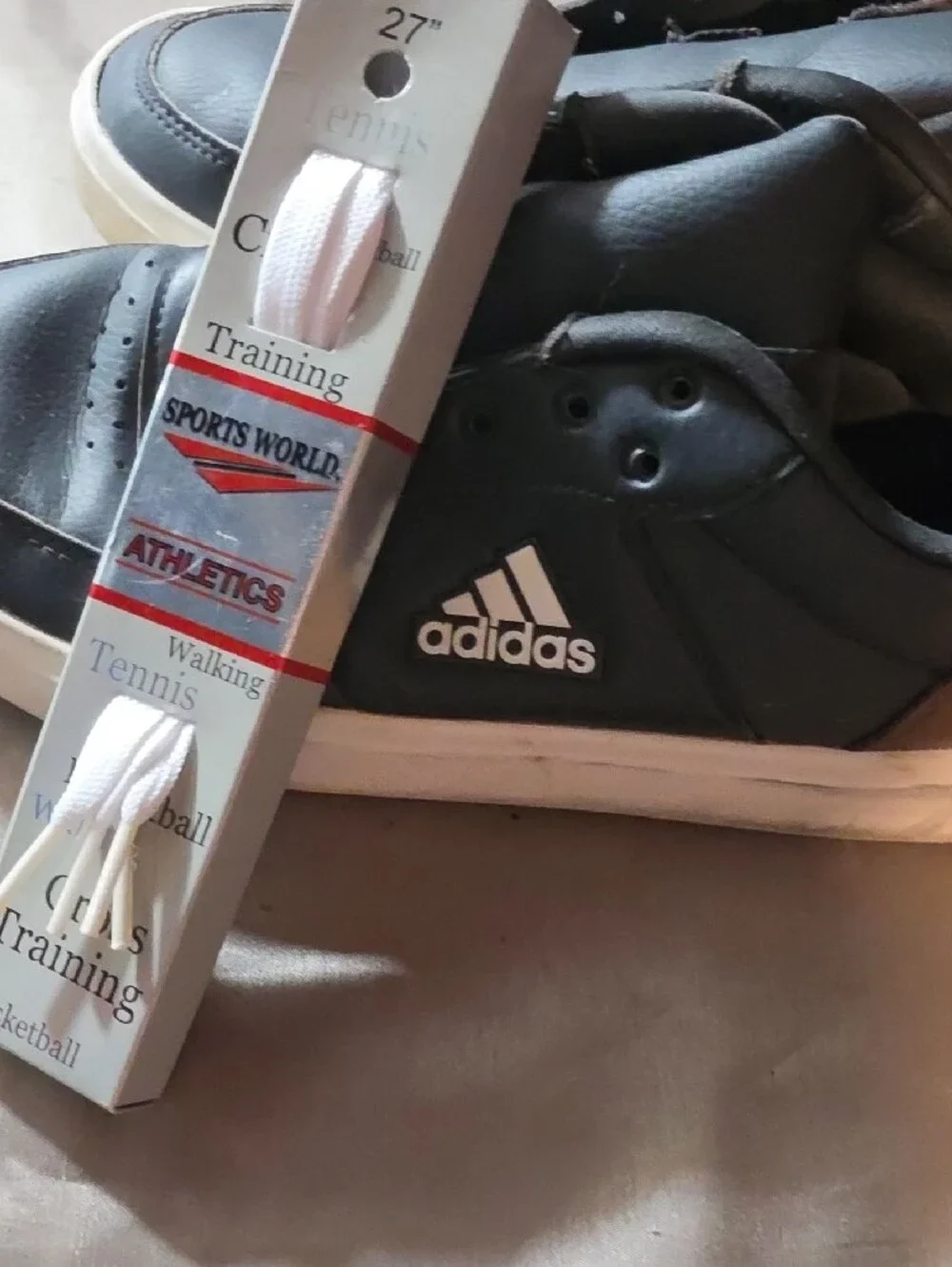 Adidas Black Sneakers with White Soles and Brown Heel Accent